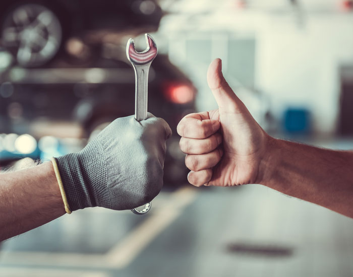 wrench and thumbs up