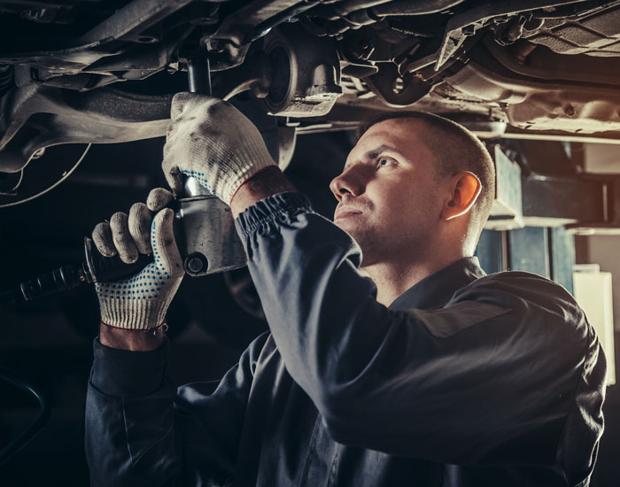 technician working under car